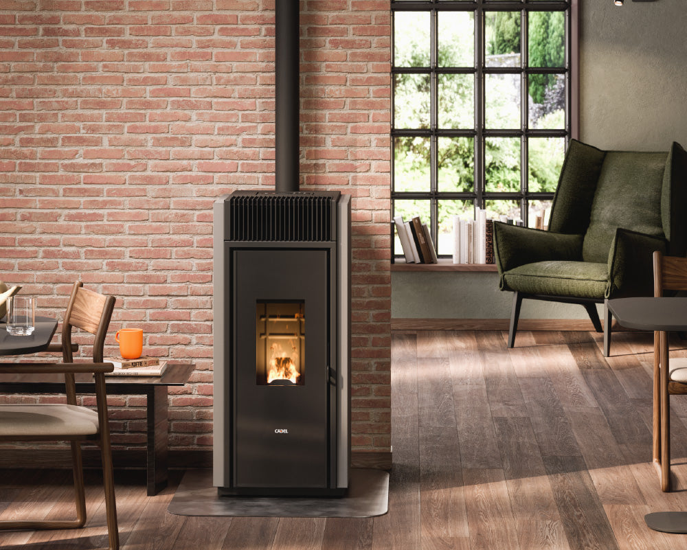 Modern living room with a freestanding stove against a brick wall.